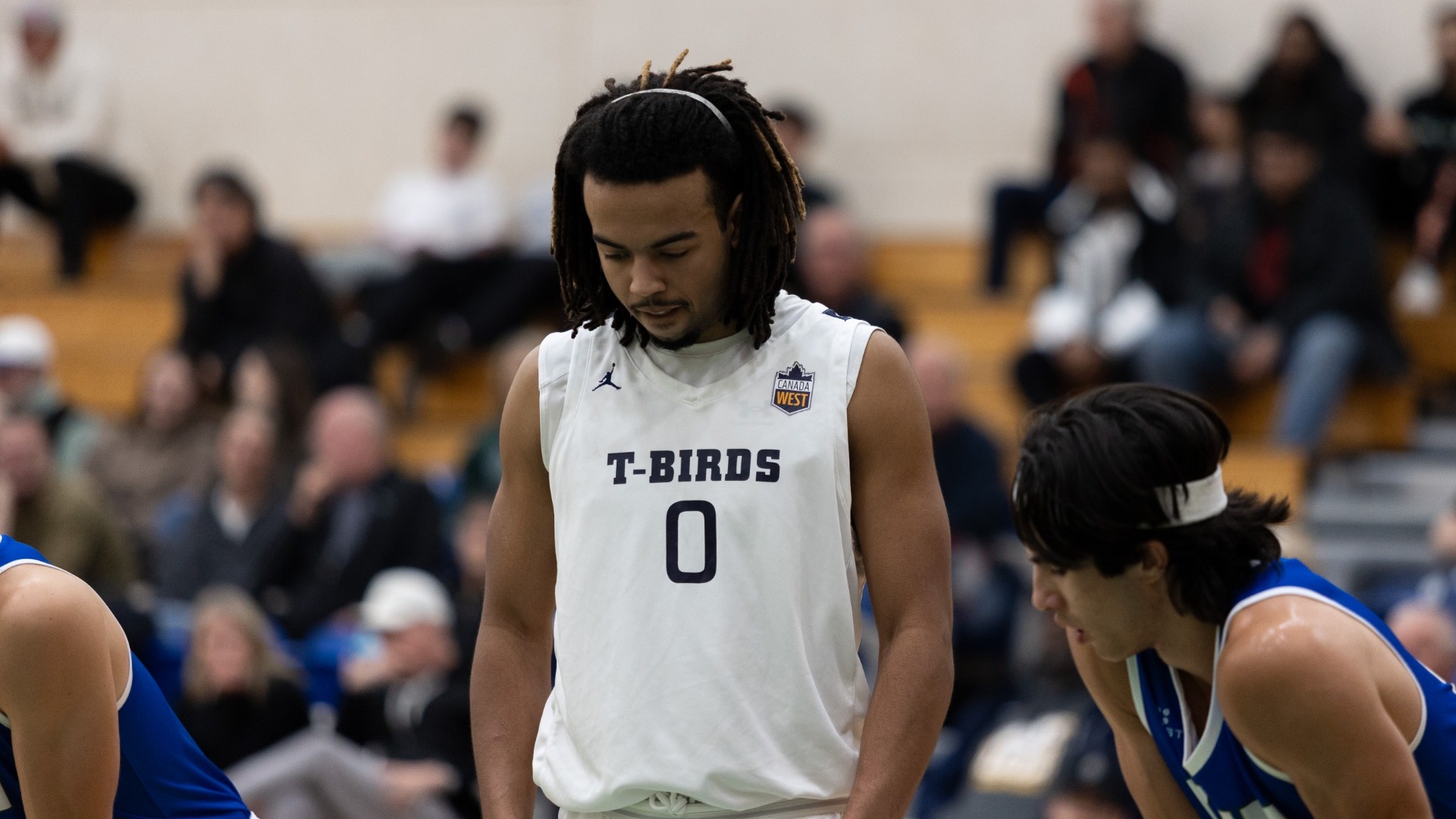 UBC Thunderbirds basketball player Nylan Roberts look down in concentration as he prepares to shoot a free throw