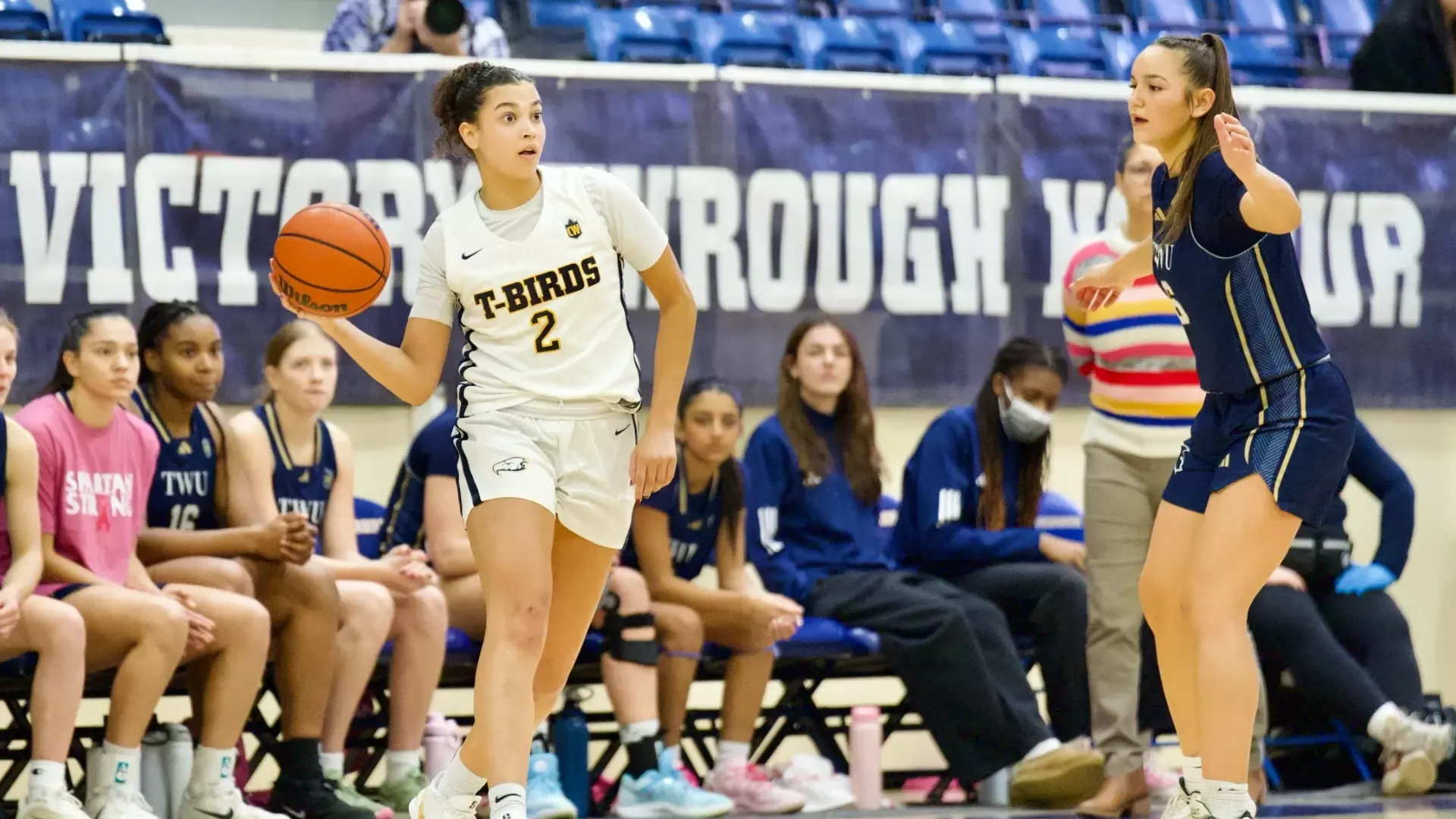 Katie Hartman holds the ball with one hand while preparing to throw it to a teammate