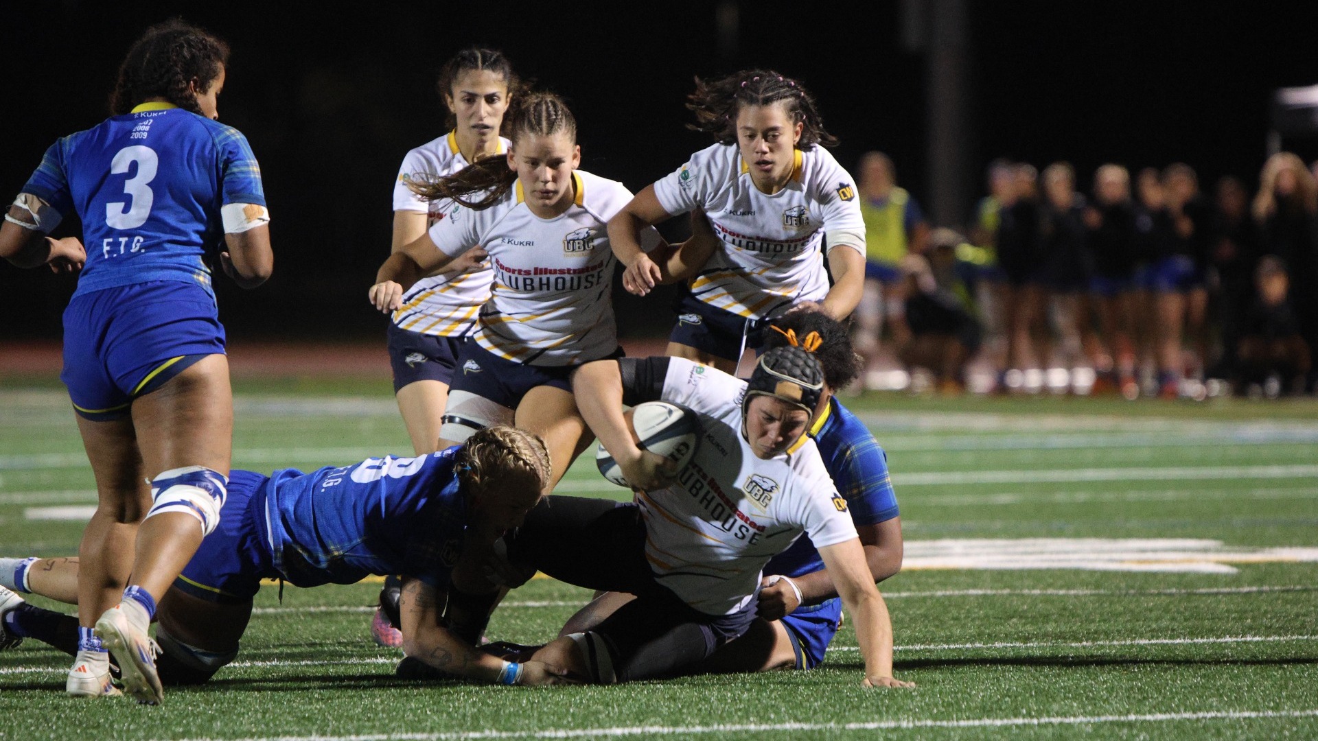 A T-Bird falls just short of the try line after being tackled by a pair of defenders during a game against the Lethbridge Pronghorns on Oct. 1, 2026 