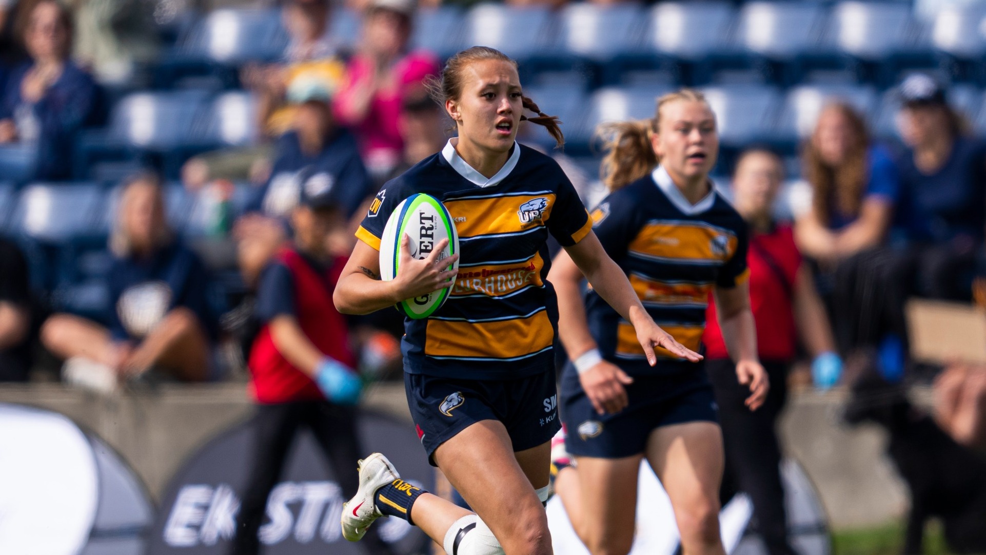 UBC's Sarah MacPherson runs upfield with the ball in her hands as a teammate trails just behind during a game against the Calgary Dinos on Sept. 19, 2026