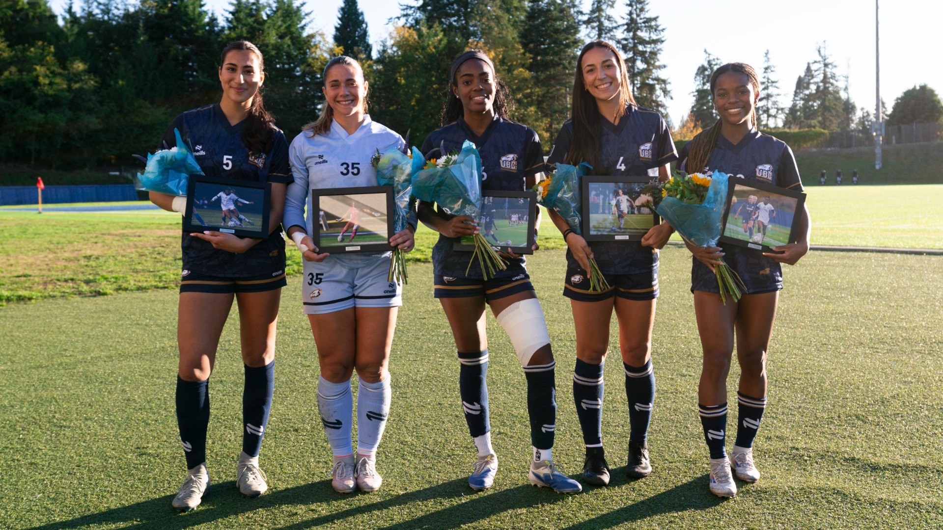 UBC women's soccer's five graduating seniors from the 2026-27 season smile and pose together with their flowers and portaits