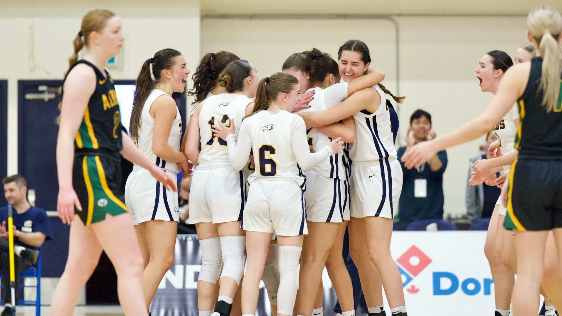 The Thunderbirds all enjoy a group hug on the court after winning the game
