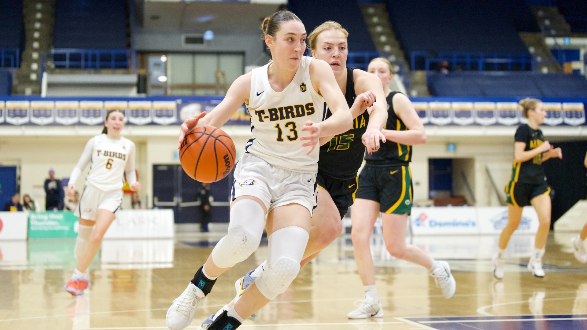 Stella LaGrange dribbles the ball with a defender trailing behind her
