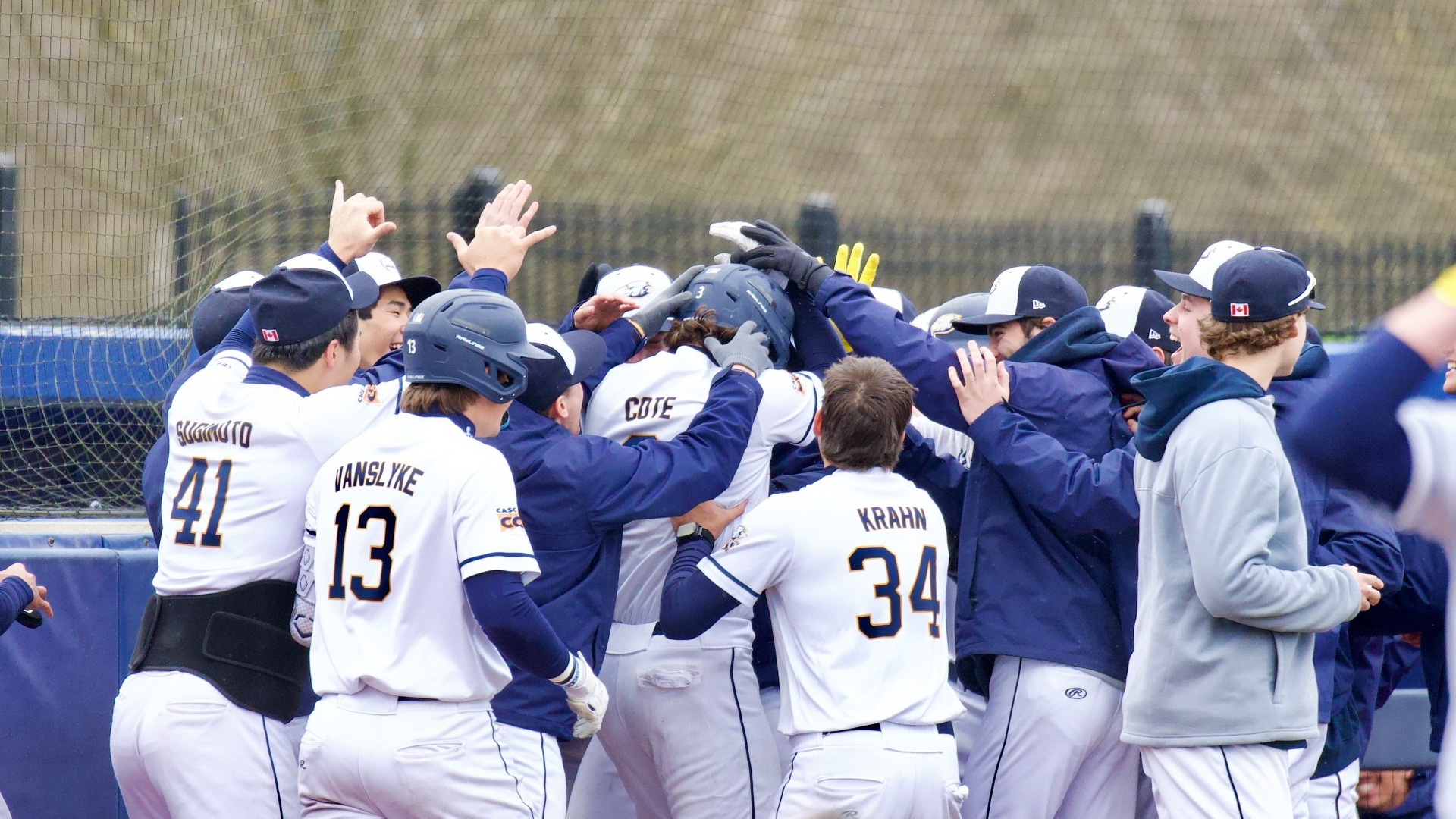 A UBC player is mobbed by his teammates after a home run