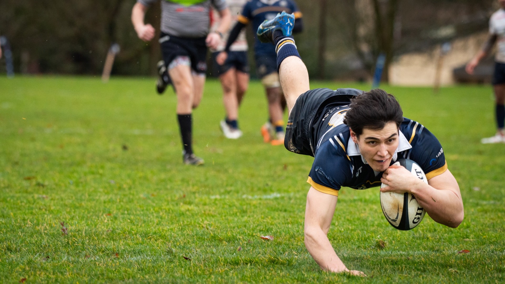 A UBC player dives into the try zone for a score
