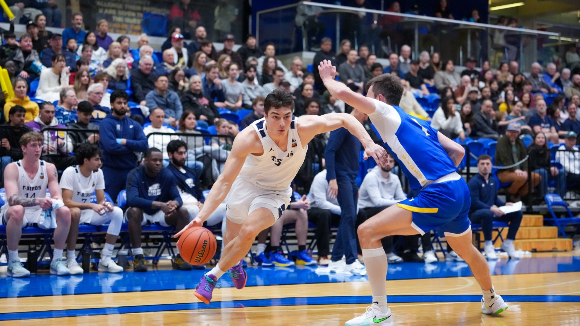 A UBC player tries to drive past his defender on the perimeter 