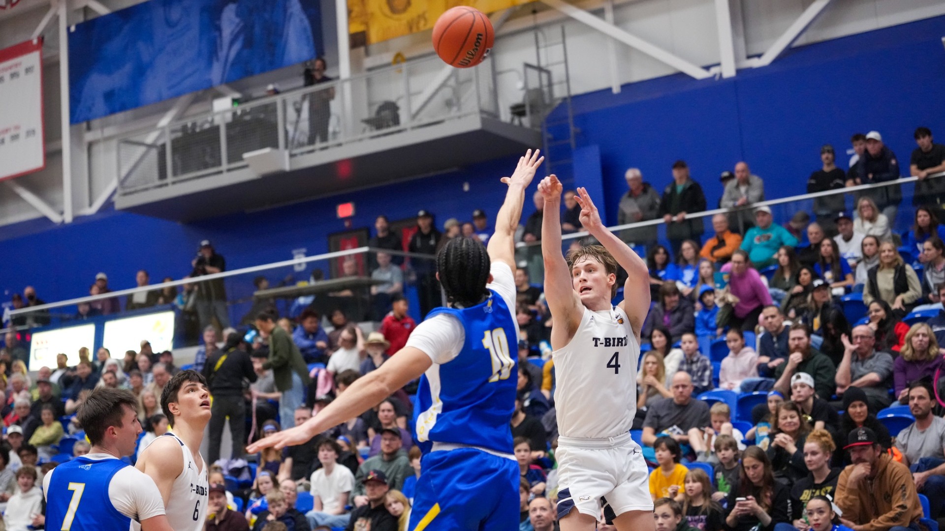 Holt Tomie fires a contested three-pointer over a defender