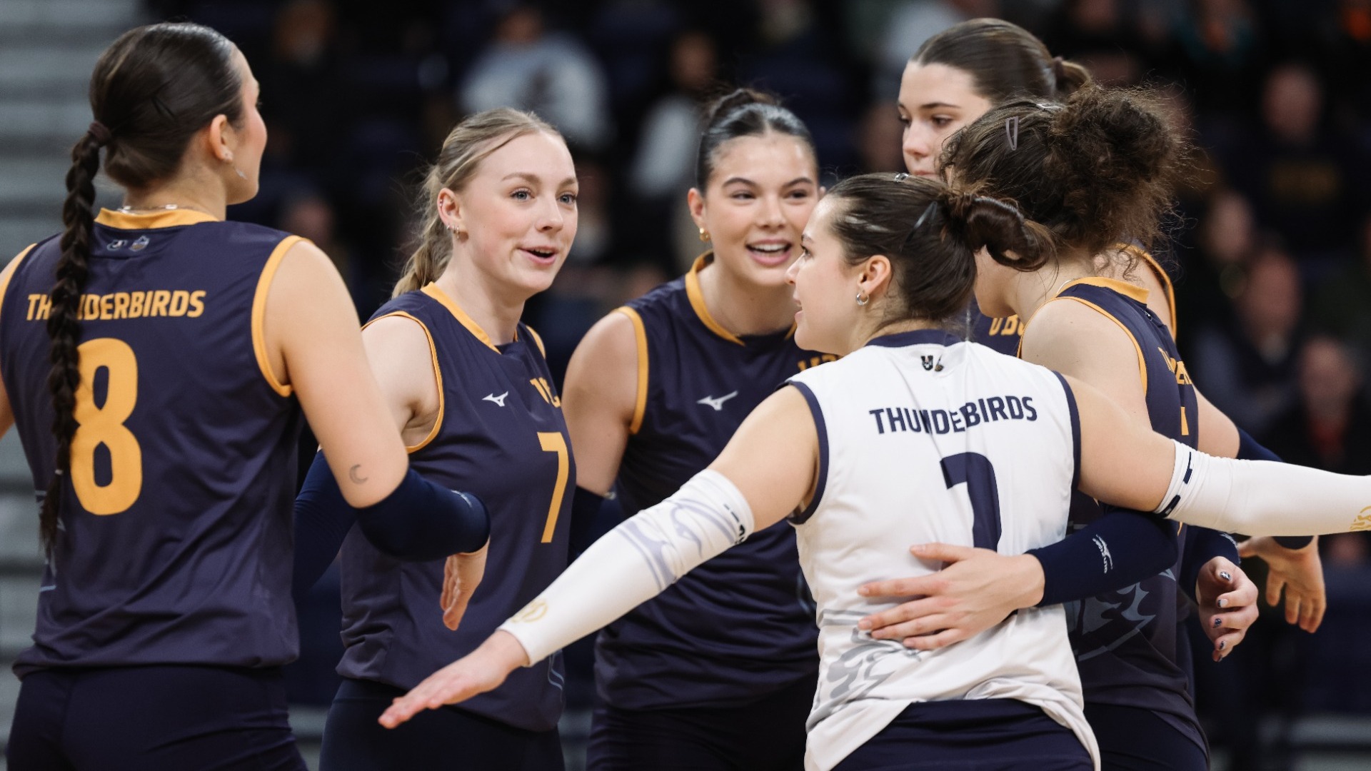 The UBC players huddle up after scoring a point