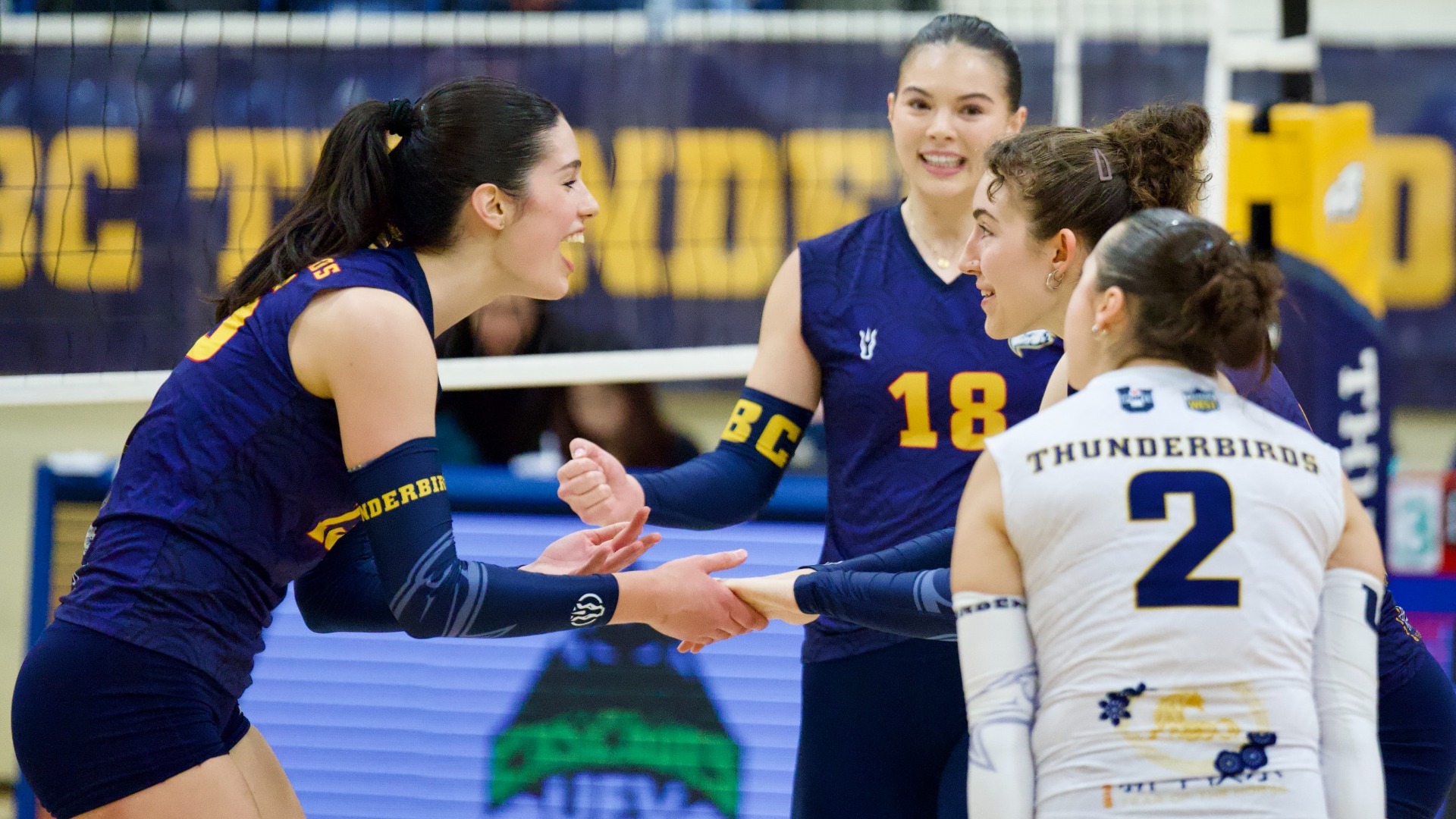 Leonora Barbulovich-Nad grabs the hand of a teammate while celebrating between plays