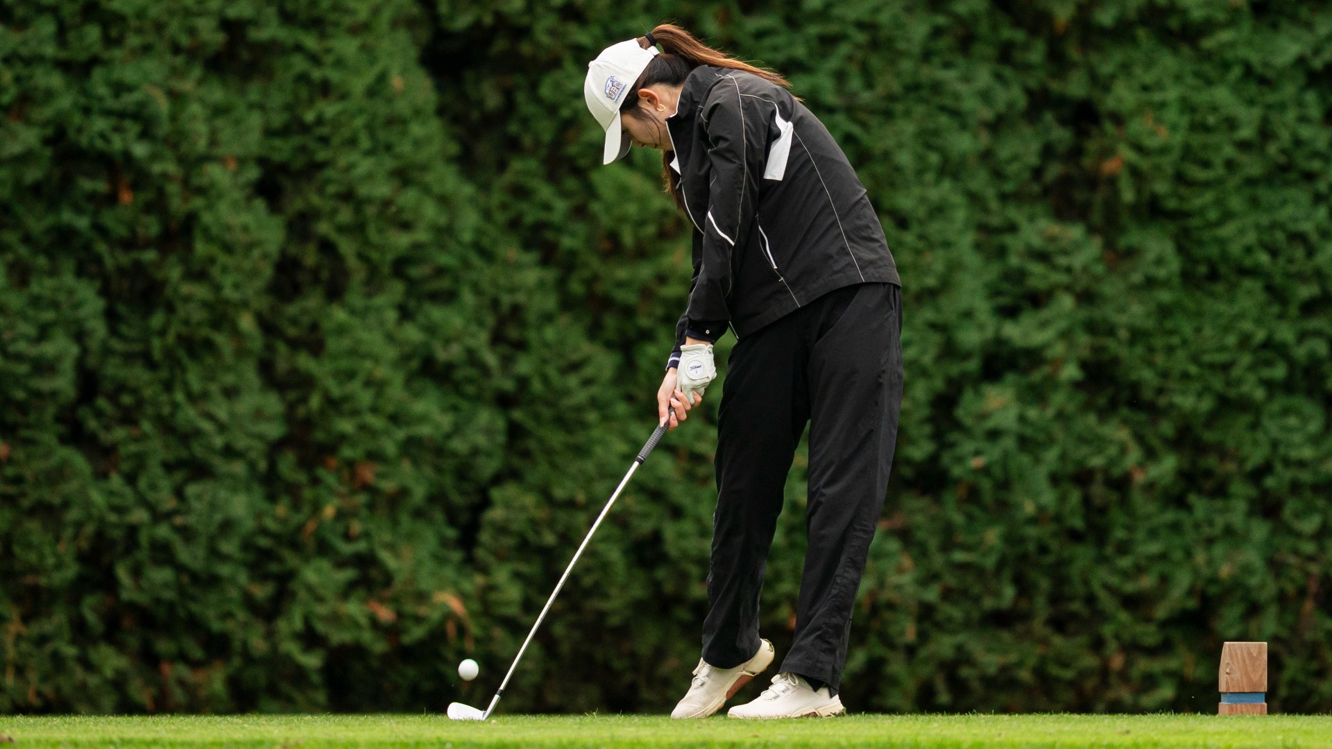 Katherine Hao swings at the ball on a tee shot