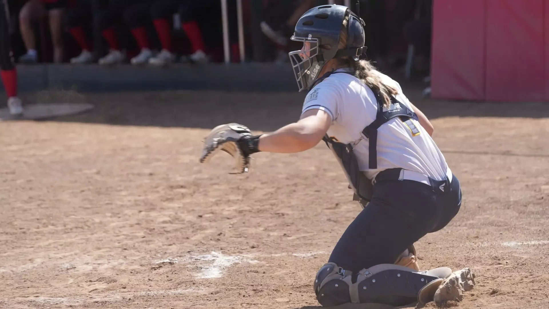 Kennedy Laird prepares for a pitch as the catcher behind the plate
