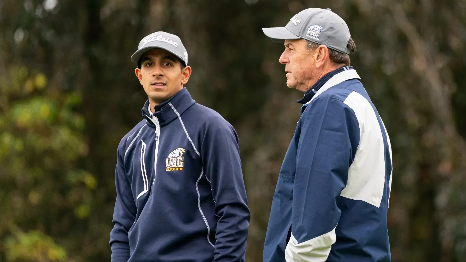 Aneesh Kaura stands next to coach Keir Smith on the course
