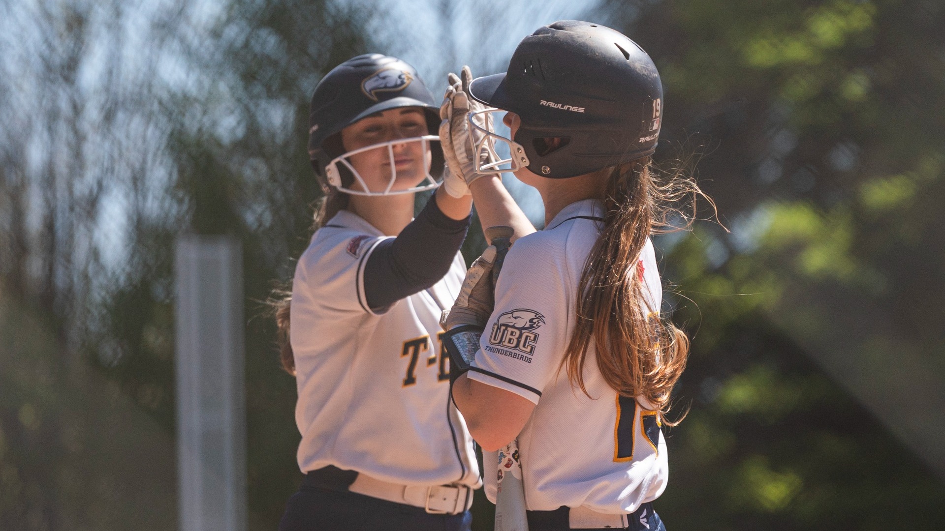 Two UBC players high-five in between plays