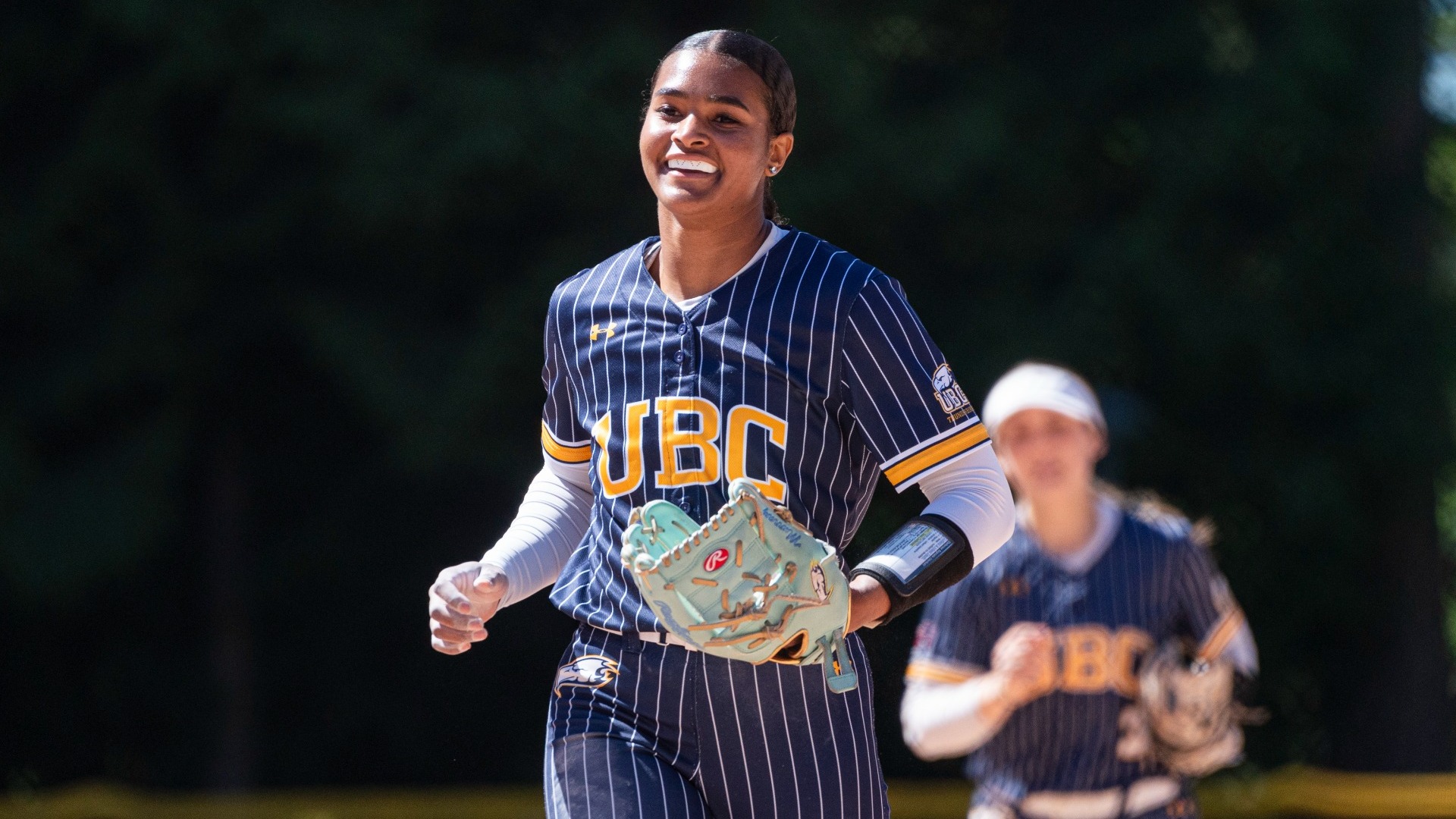 Carleen Murray is all smiles as she runs off the field in between innings 