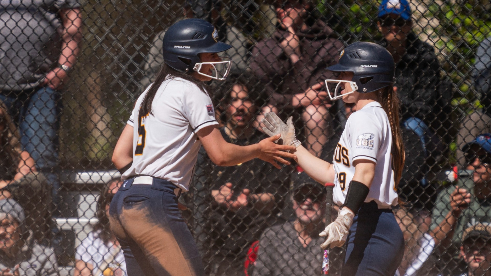 Lauren Hounsell and Brielle Donoghue high-five happily after a play