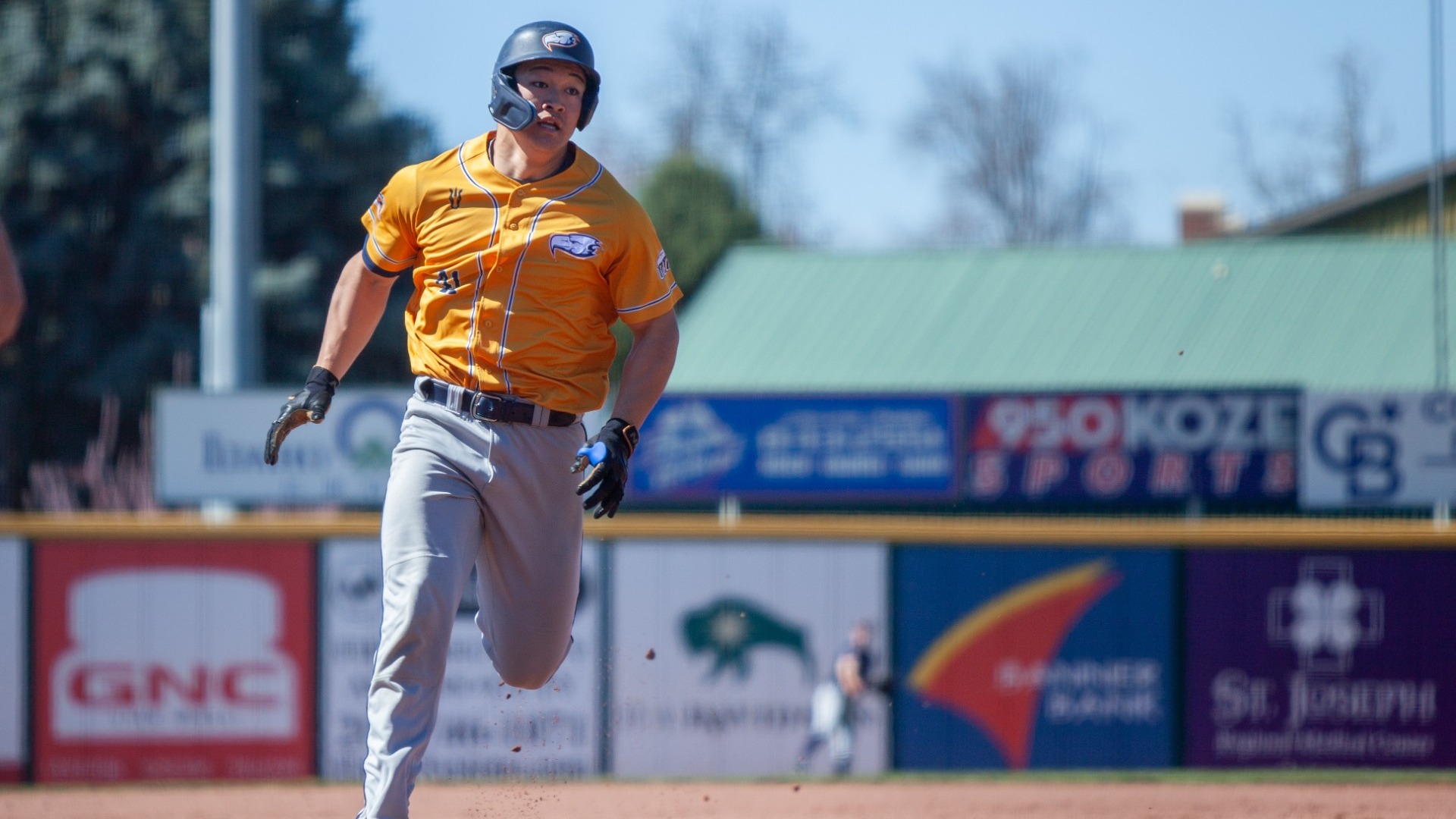 A UBC player runs along the basepaths