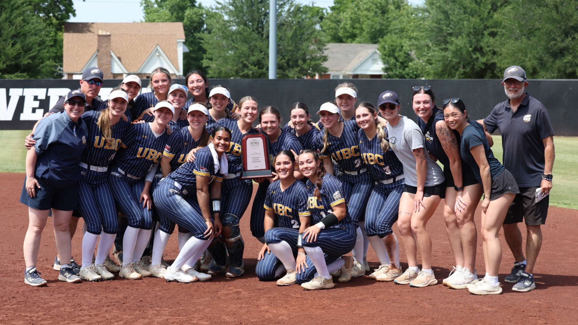 The UBC players and staff pose with their trophy after winning the NAIA regional final