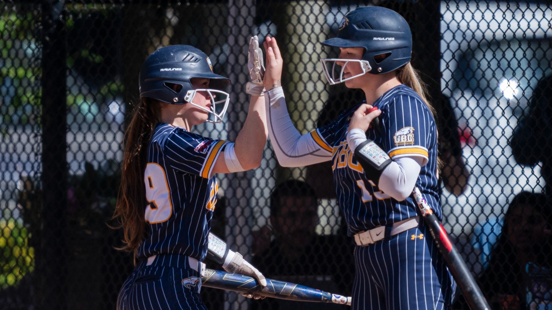 Mattea Burrill and Brielle Donoghue high-five in between plays