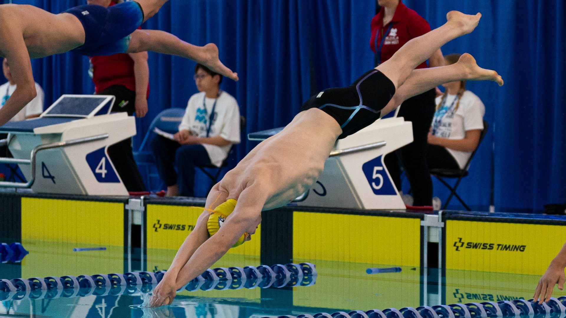 Olivier Risk dives into the water at the start of his race