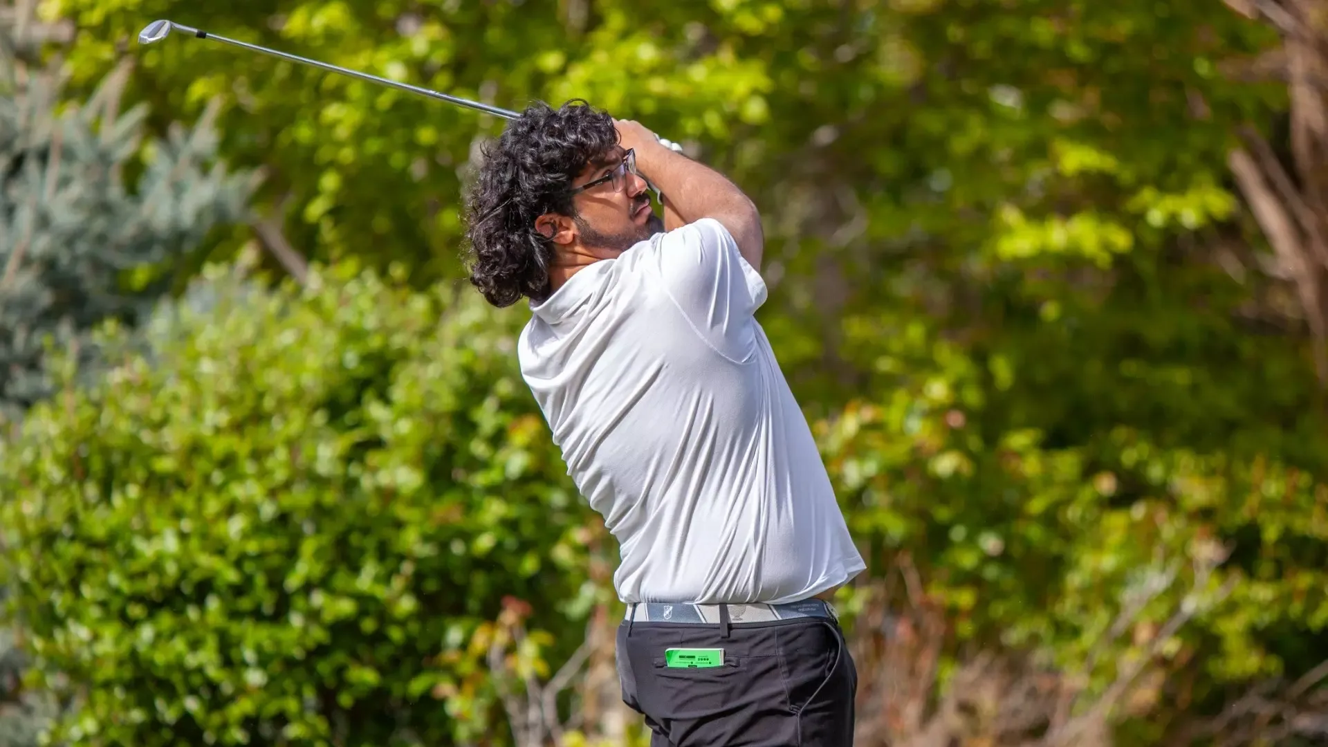 Manpreet Lalh holds his follow-through after hitting a shot on the fairway