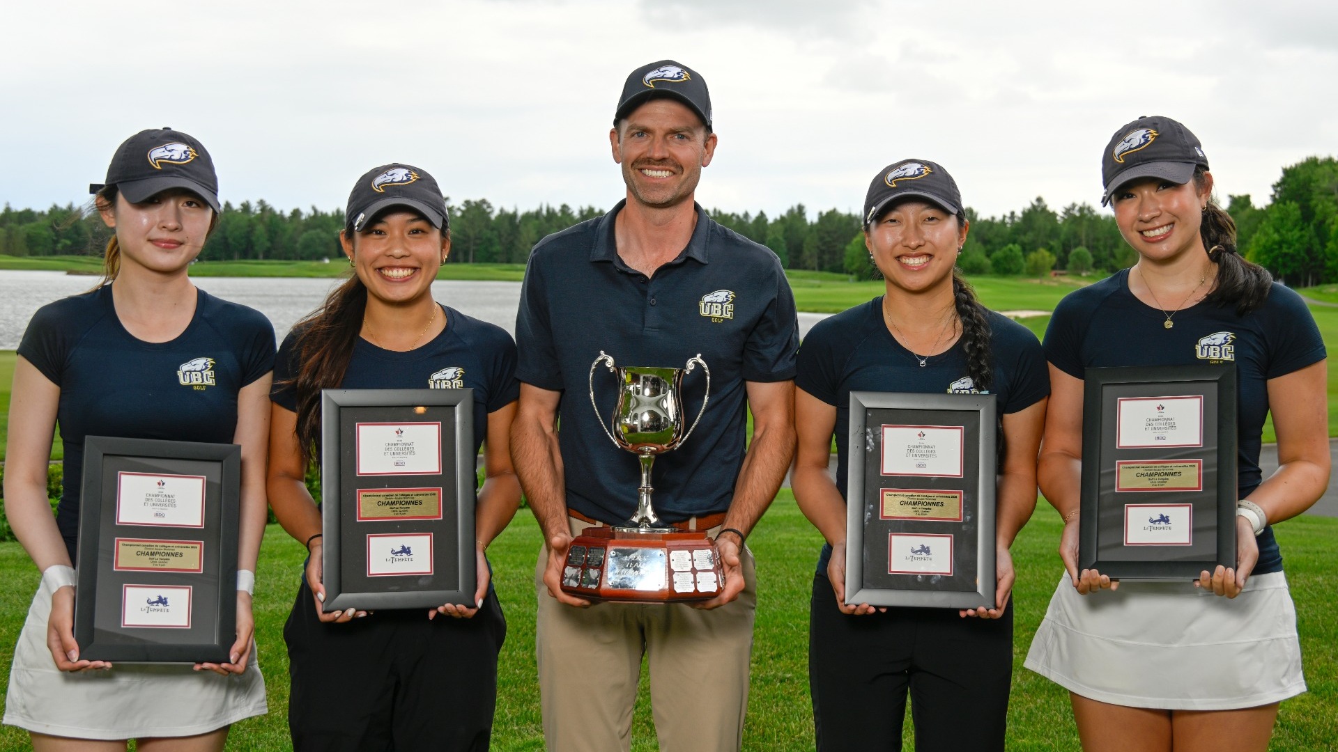 The victorious UBC Thunderbirds and program advisor Cory Renfrew pose with Canadian Championship trophy