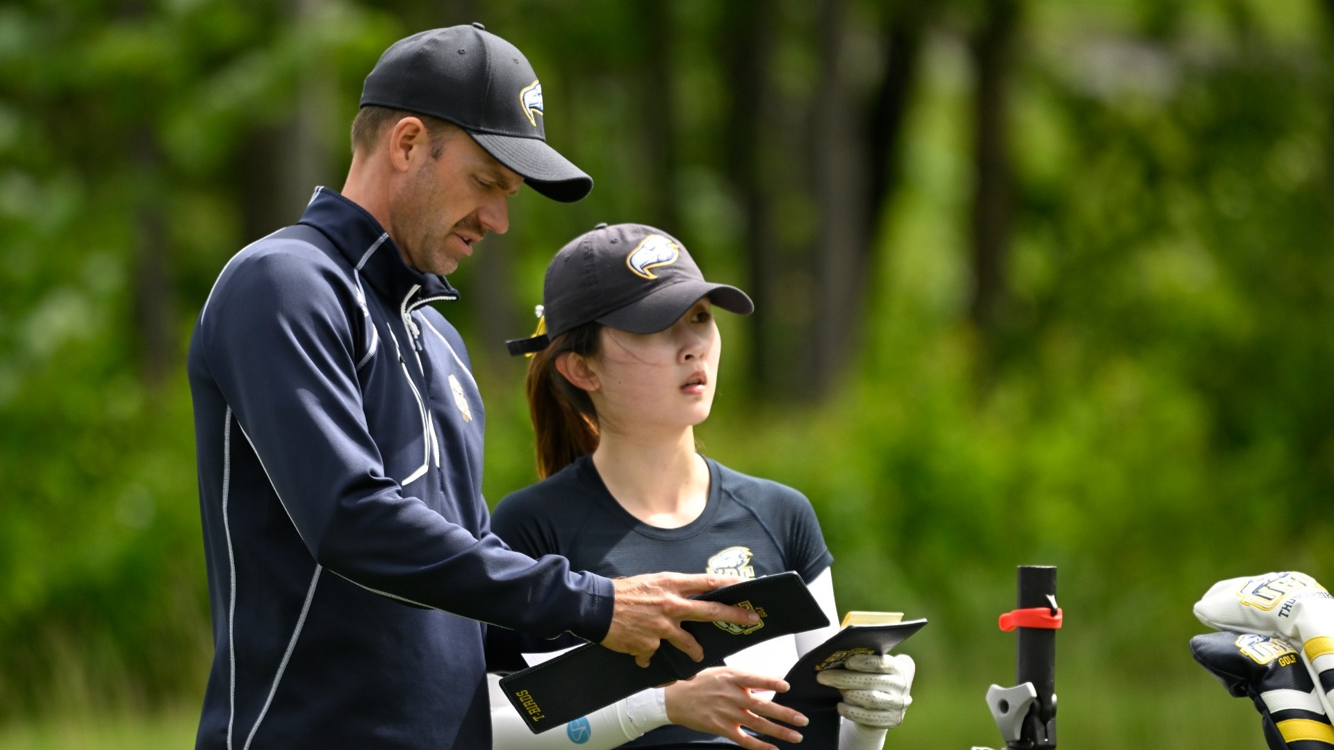 Cory Renfrew and Katherine Hao study notebooks together on the course