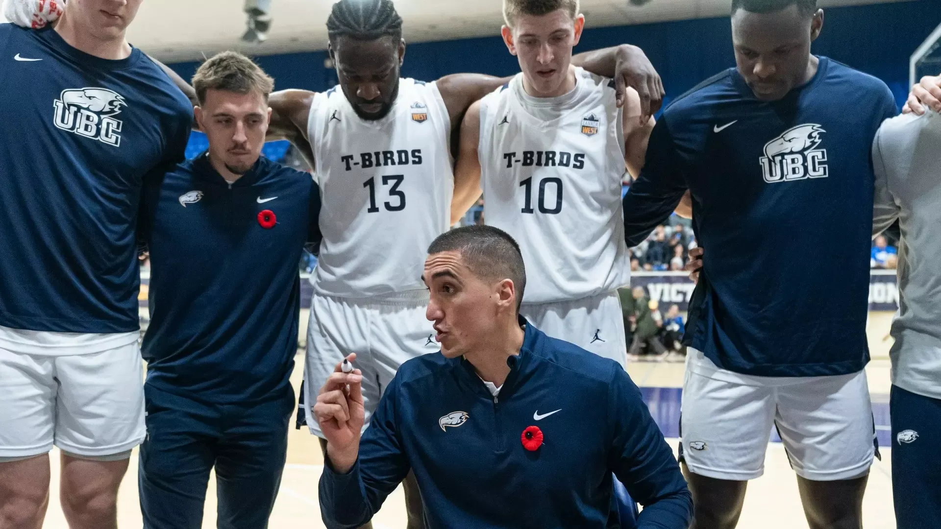 Phil Jalalpoor talks to his team while in the centre of a huddle during a timeout
