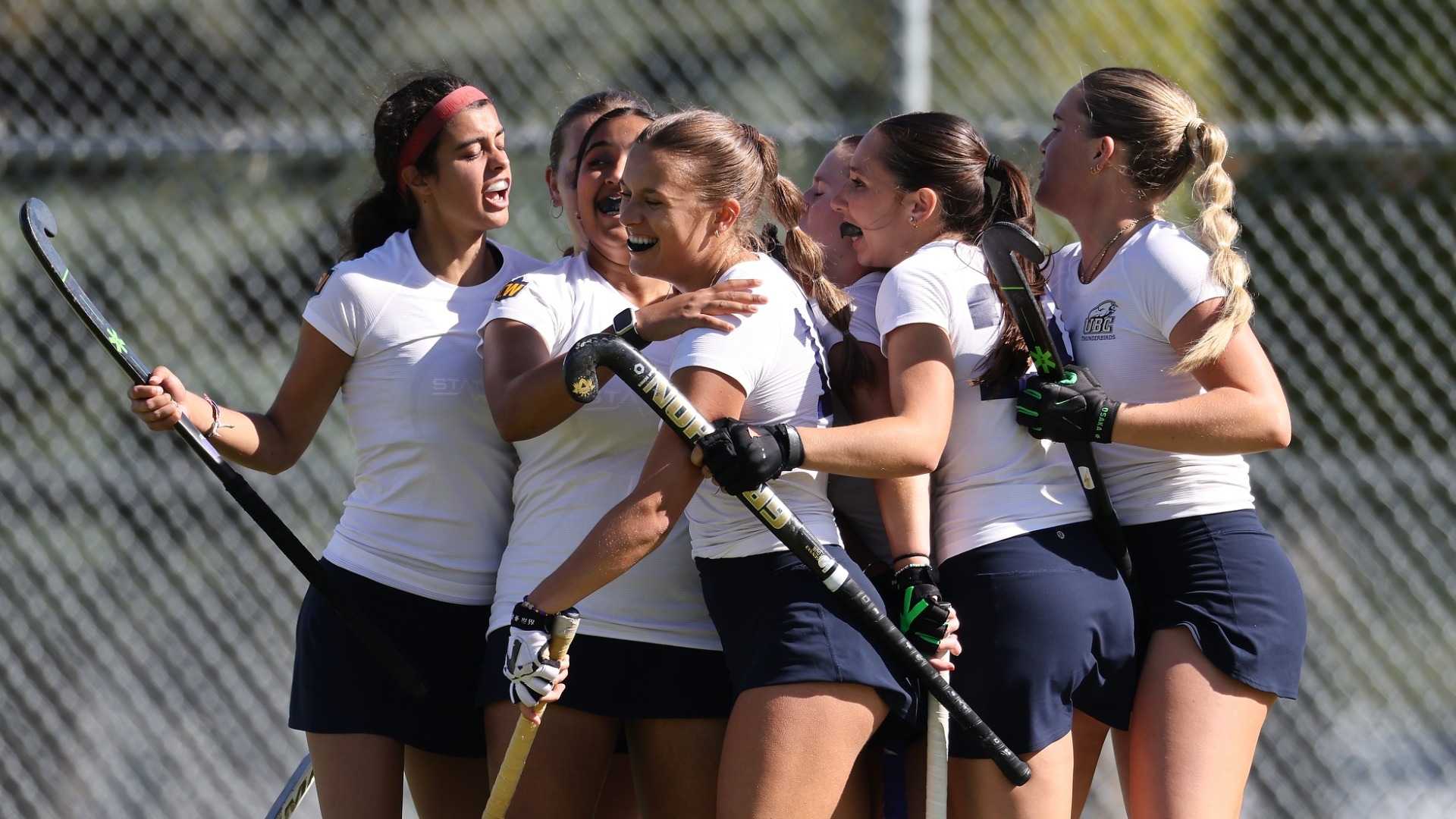 A group of UBC players celebrate together after a goal