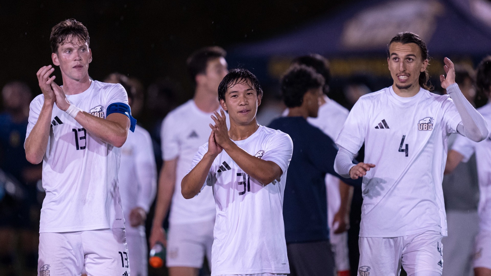 Eric Lajeunesse, Brandon Momotani, and Lucas Dasovic clap for the crowd after the UBC Thunderbirds men's soccer team defeated the Trinity Western Spartans 1-0 in the Jumpstart game at Thunderbird Stadium