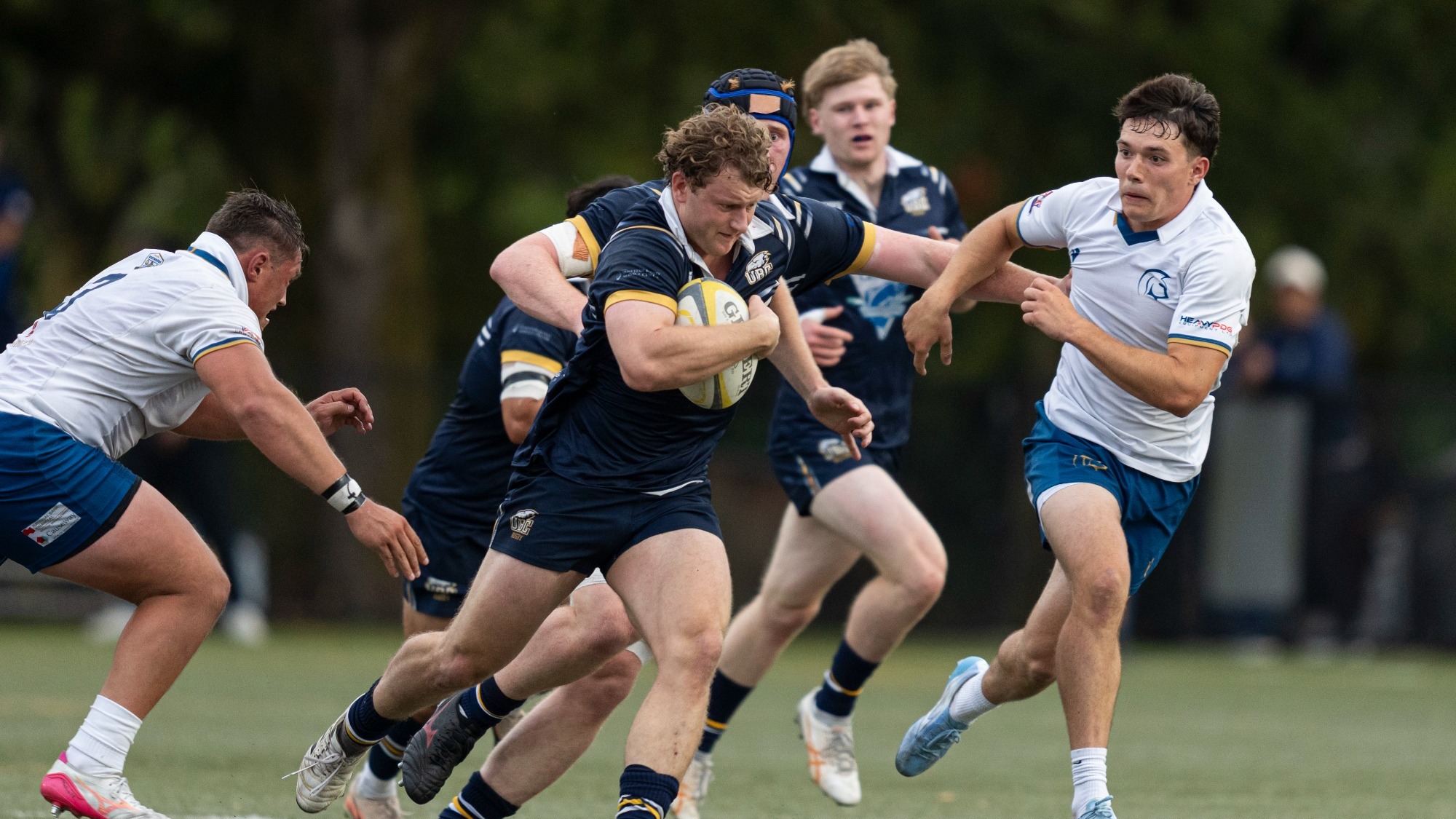 A UBC player fights off the defence as he tries to work his way up the field against the TWU Spartans on Sept. 4, 2026