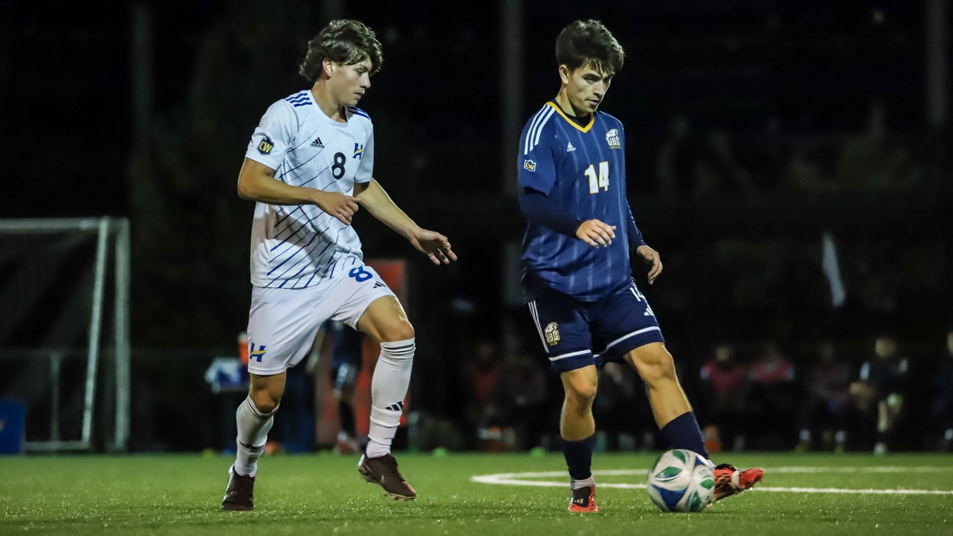 Oliver Herbert looks around while holding onto the ball close to a Heat defender