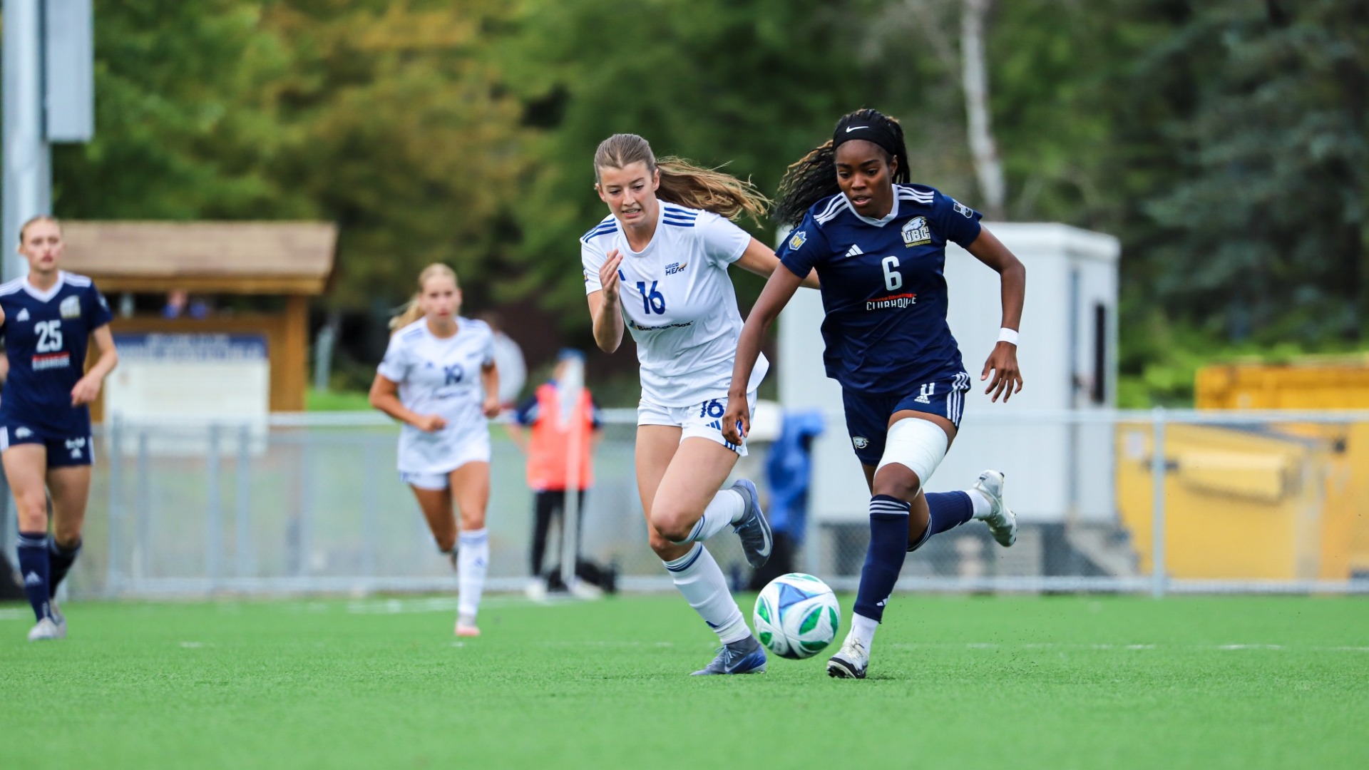 Taiya Dennehy dribbles the ball forward while pursued by a defender