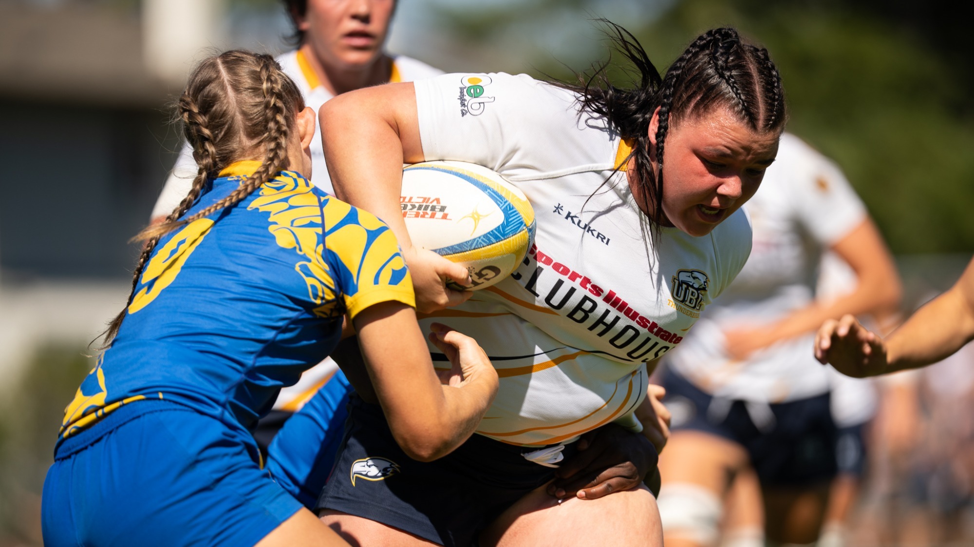 A T-Bird fights through tackle attempts from a pair of Vikes in a game against the UVic on Sept. 5, 2026