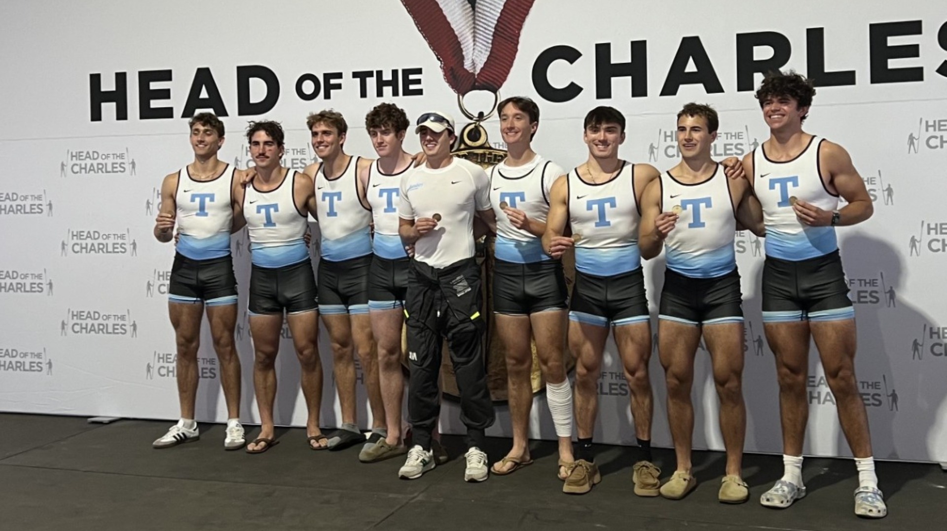 Men's Rowing's 1V8 on the podium at the 2025 Head of the Charles.