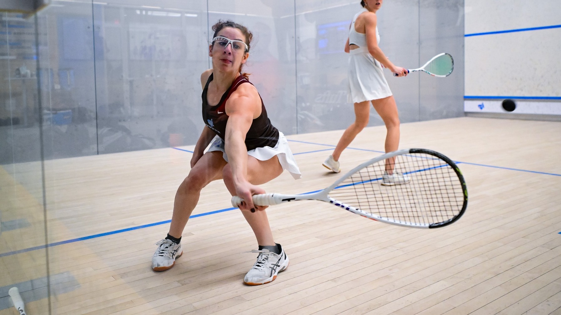 Chloe Bergam Picks Up Shot for Tufts women's squash