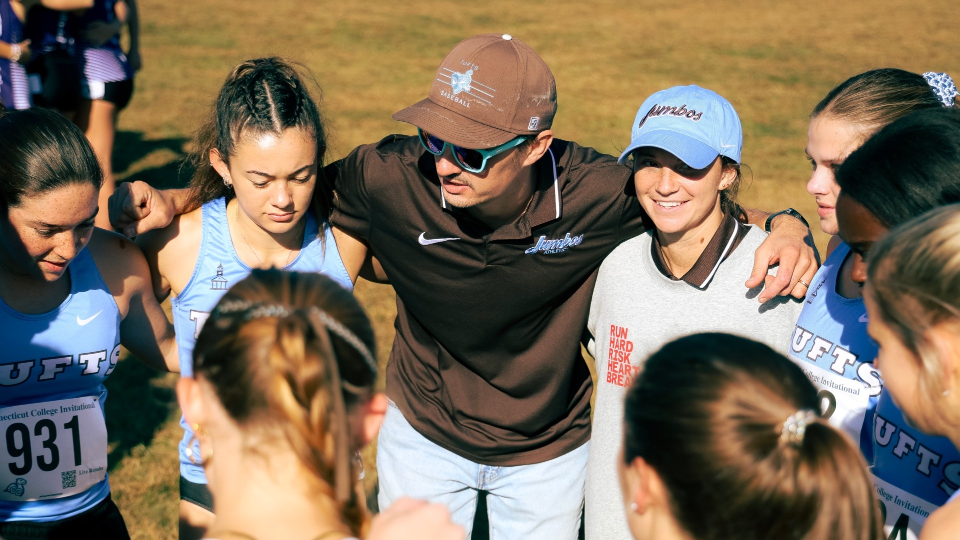 Coach Norton meets with the Tufts women's team prior to a race.