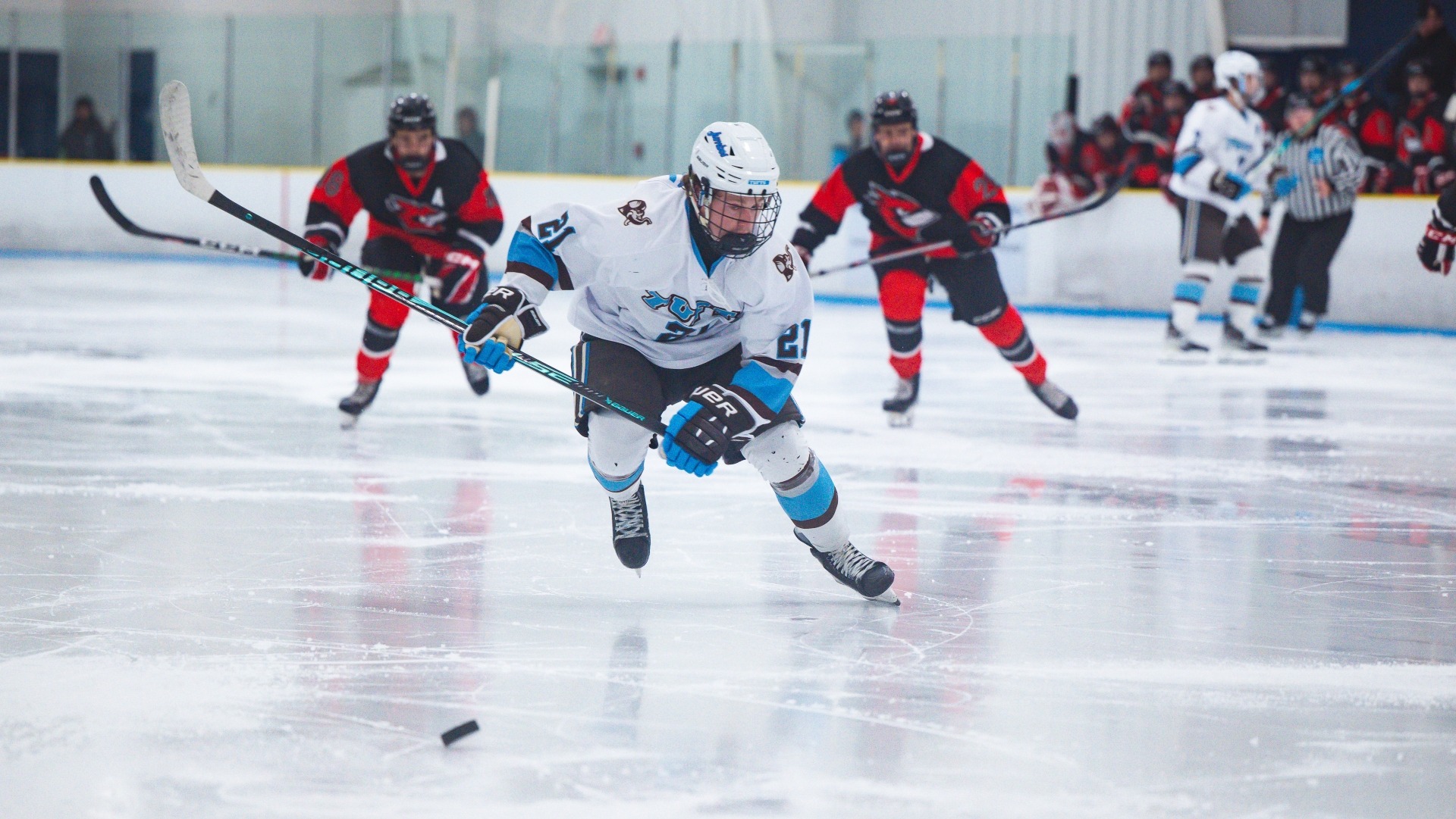 Trace Norwell skates up ice against Wesleyan University.