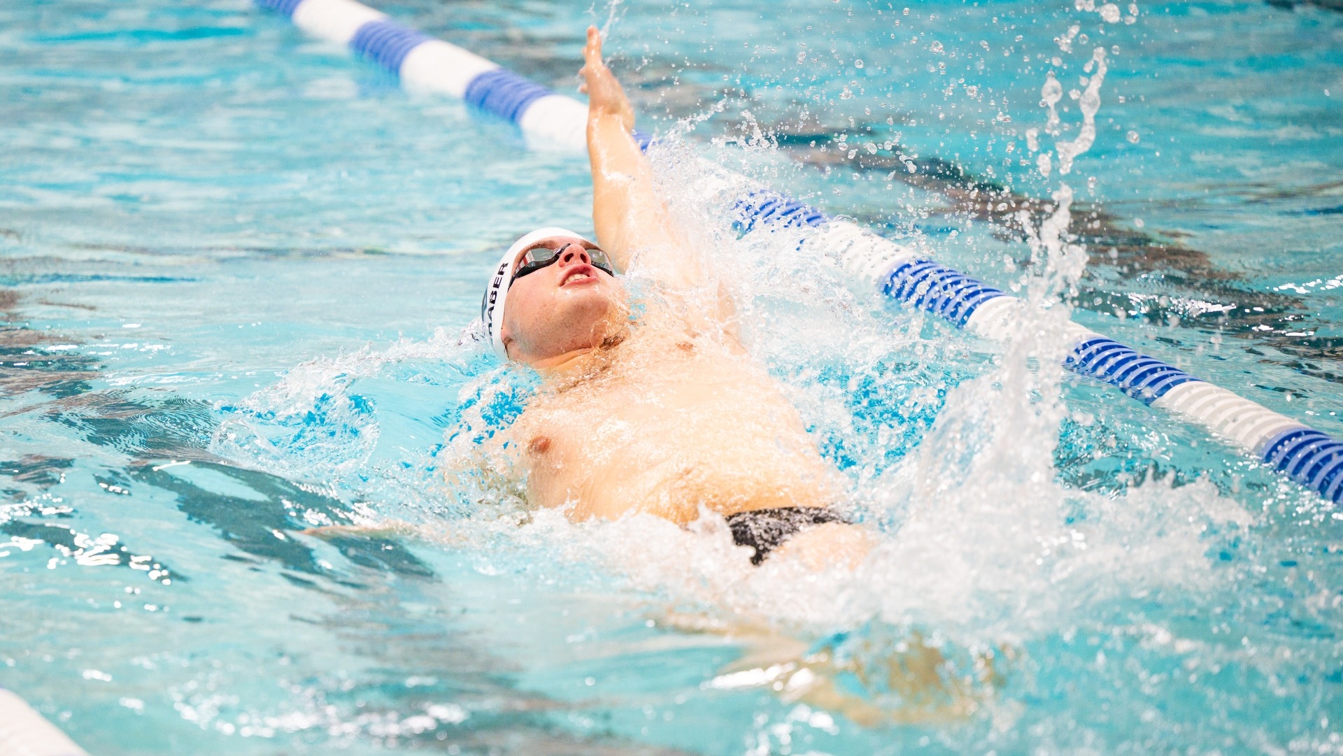 Seth Graber swims the backstroke for Tufts against Brandeis.