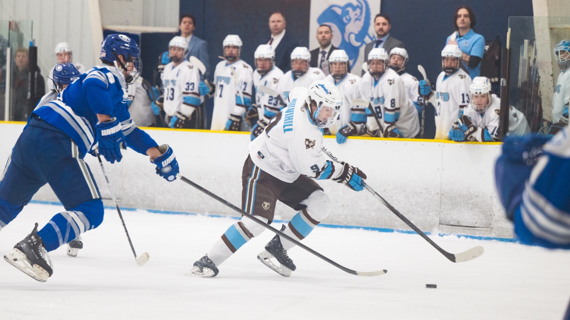 John Mulvihill skates with the puck against Colby College.