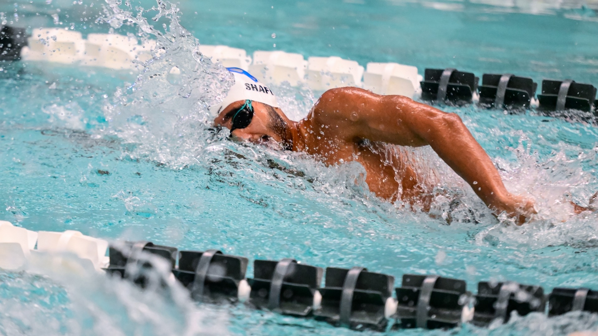 Rafae Shafi swims a freestyle event for the Tufts Jumbos.