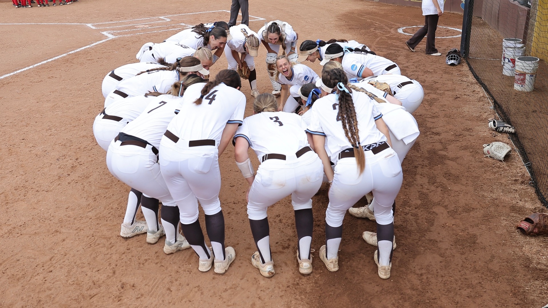 The Tufts softball team huddles before a game at the NCAA Regional.