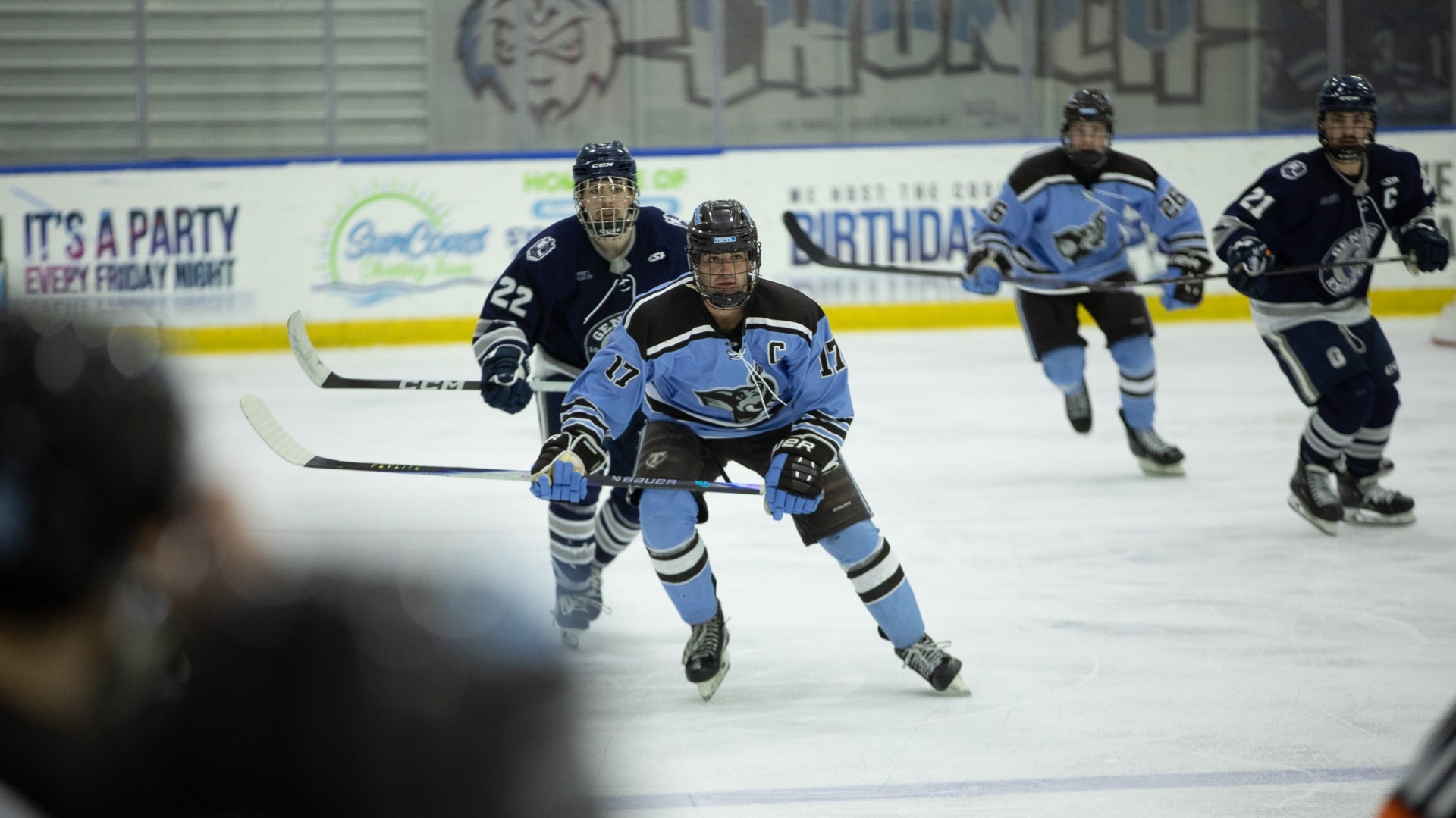Max Resnick chases the puck against Geneseo at the Tampa College Hockey Invitational.