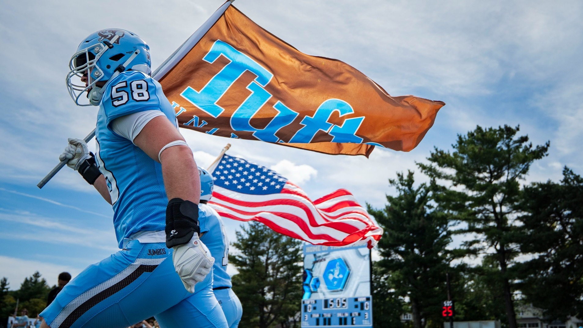 Liam Mayer Runs Out of Tufts Tunnel With Flag
