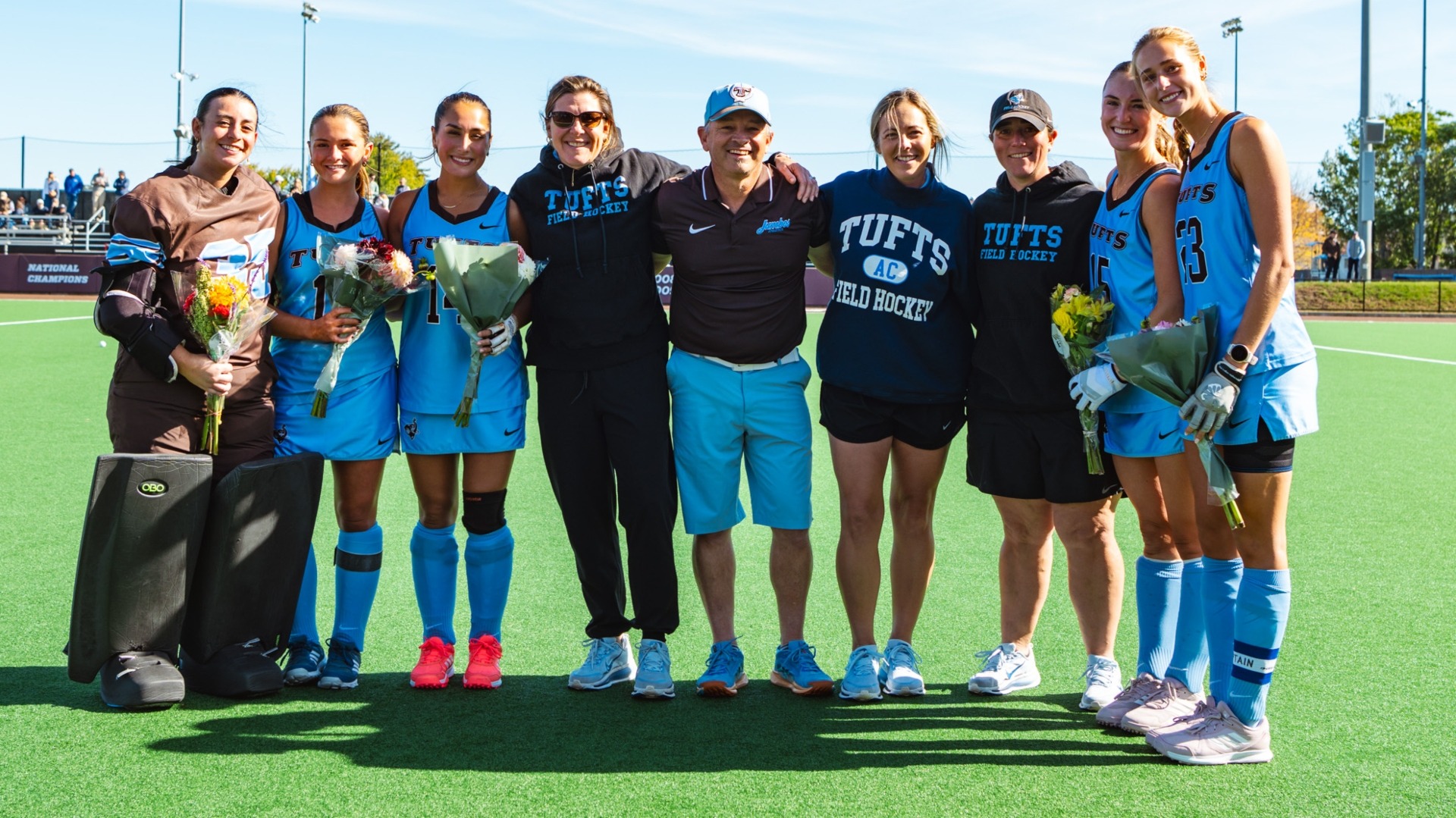 Field Hockey seniors pose with the coaches on Senior Day.