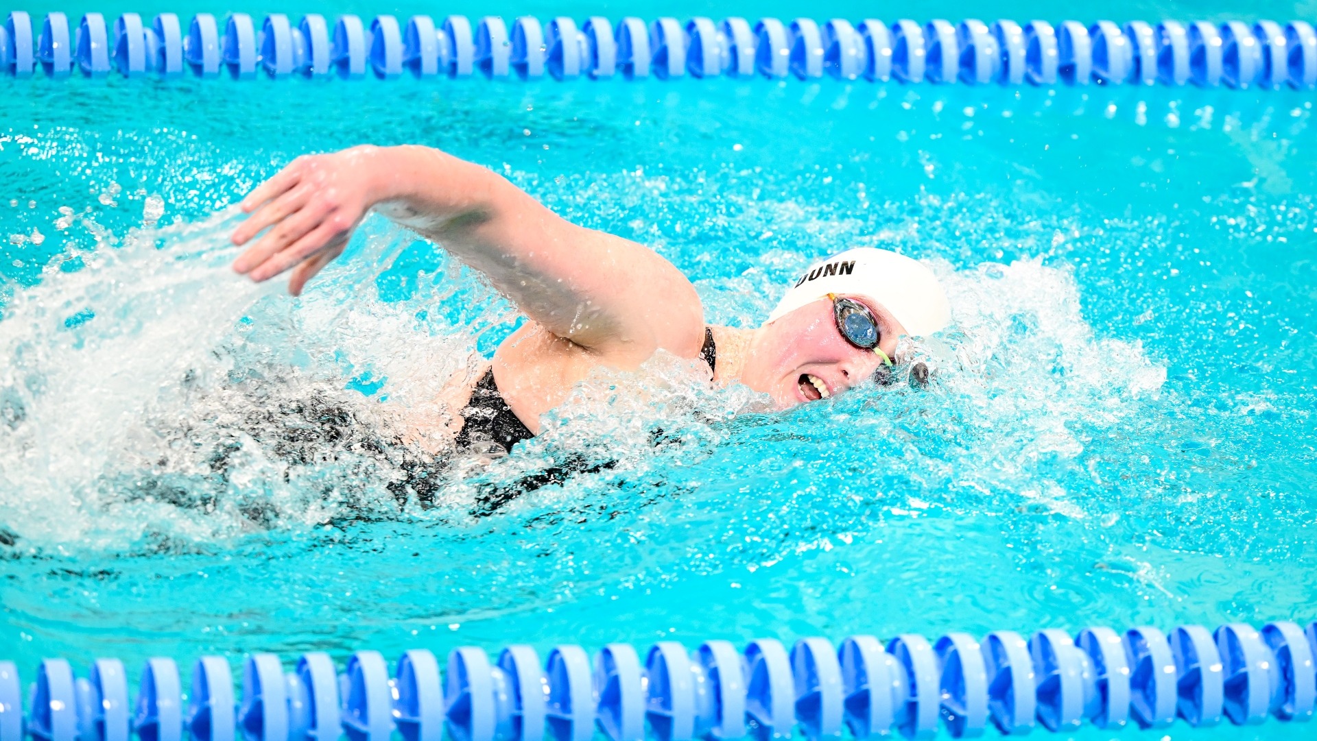 Madeleine Dunn swims in a home meet versus MIT.