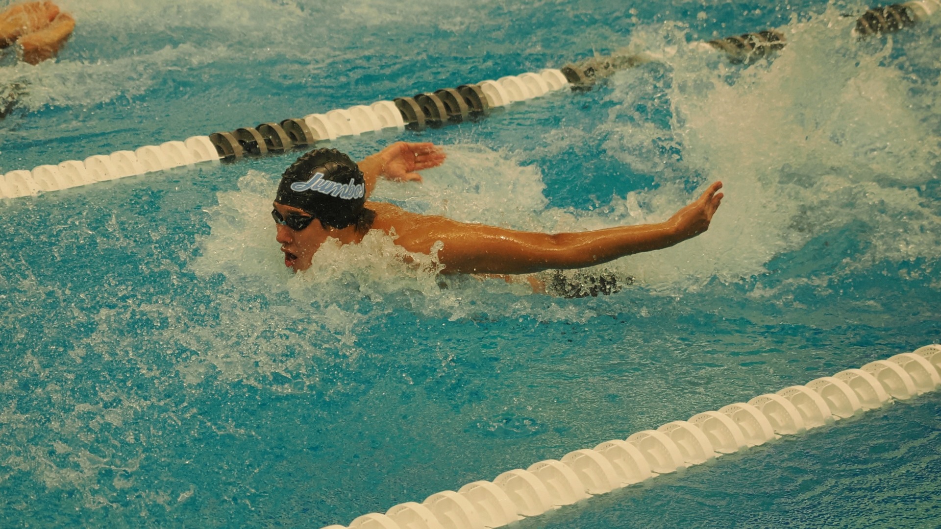 A Tufts swimmer competes in a butterfly event at the NESCAC Championships.