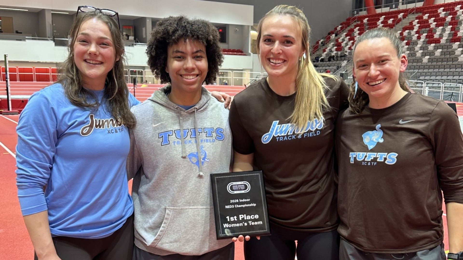 The Tufts Women's Track & Field captains with the New England Indoor Championship plaque.