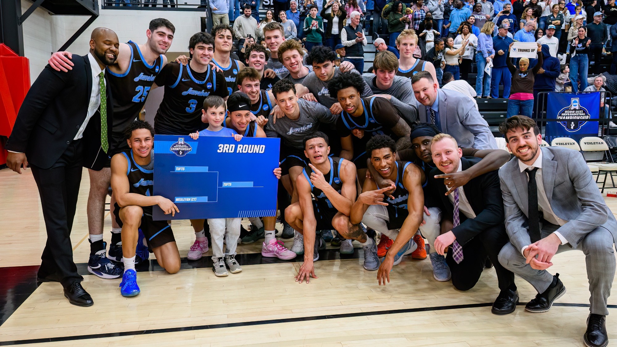 Men's Basketball Poses As A Team After Win at Wesleyan March 14.