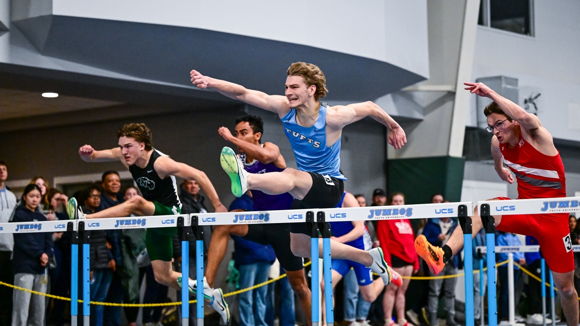 Josh Wilkie clears a hurdle in a race at the Gantcher Center.