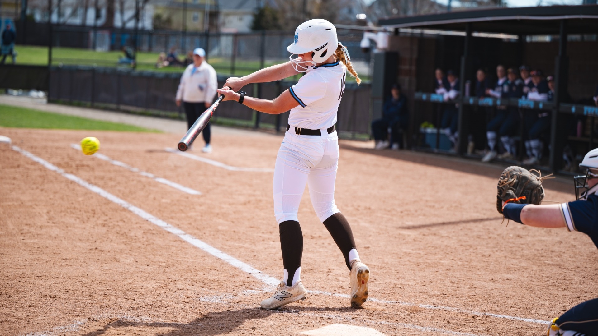 Ella Malin connects during Tufts' doubleheader at home against Trinity College.